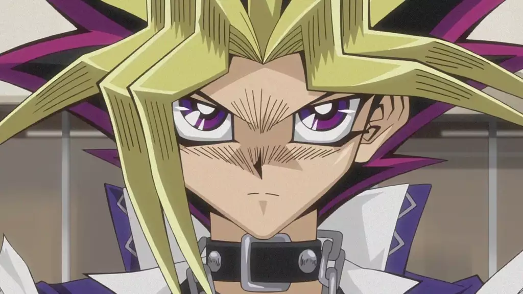 Yugi Mutou stares intensely as he prepares to duel.