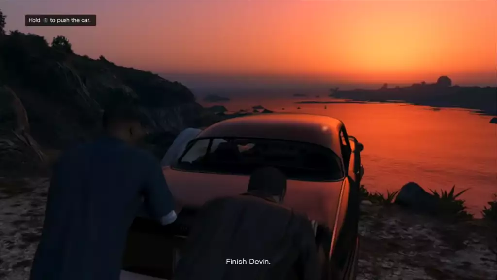 Michael, Trevor and Franklin push the car off the cliff into the sea.